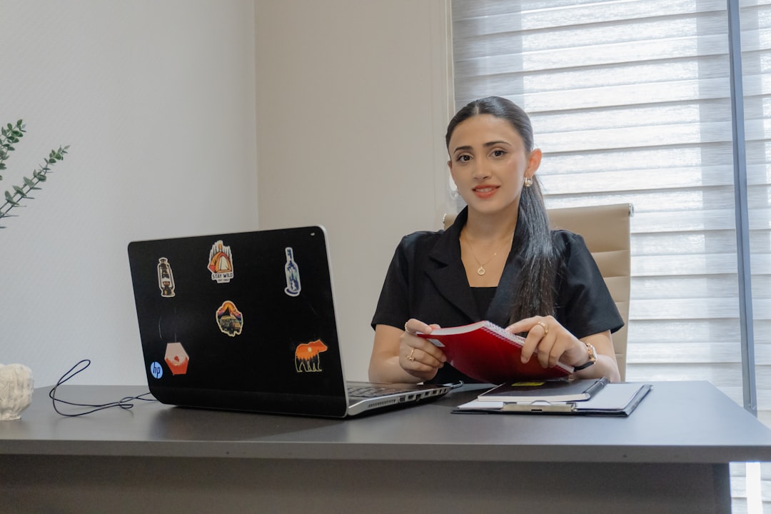 woman-working-at-a-desk-with-a-laptop-and-laptop-k1ghtzbgcxm